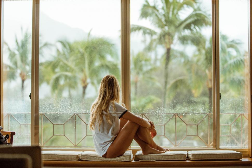 sober woman looking out the window in peaceful contemplation